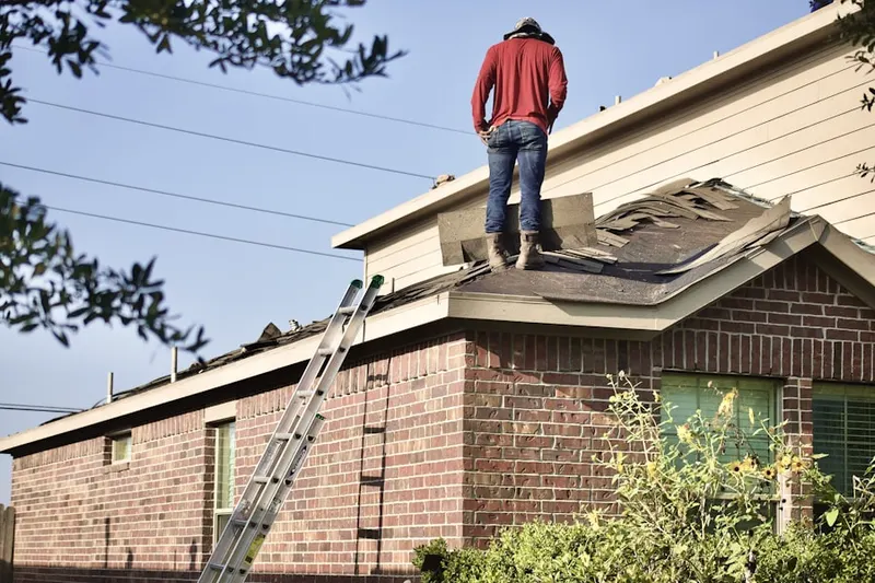 Professional roofer working on a residential roof in Lake Ridge